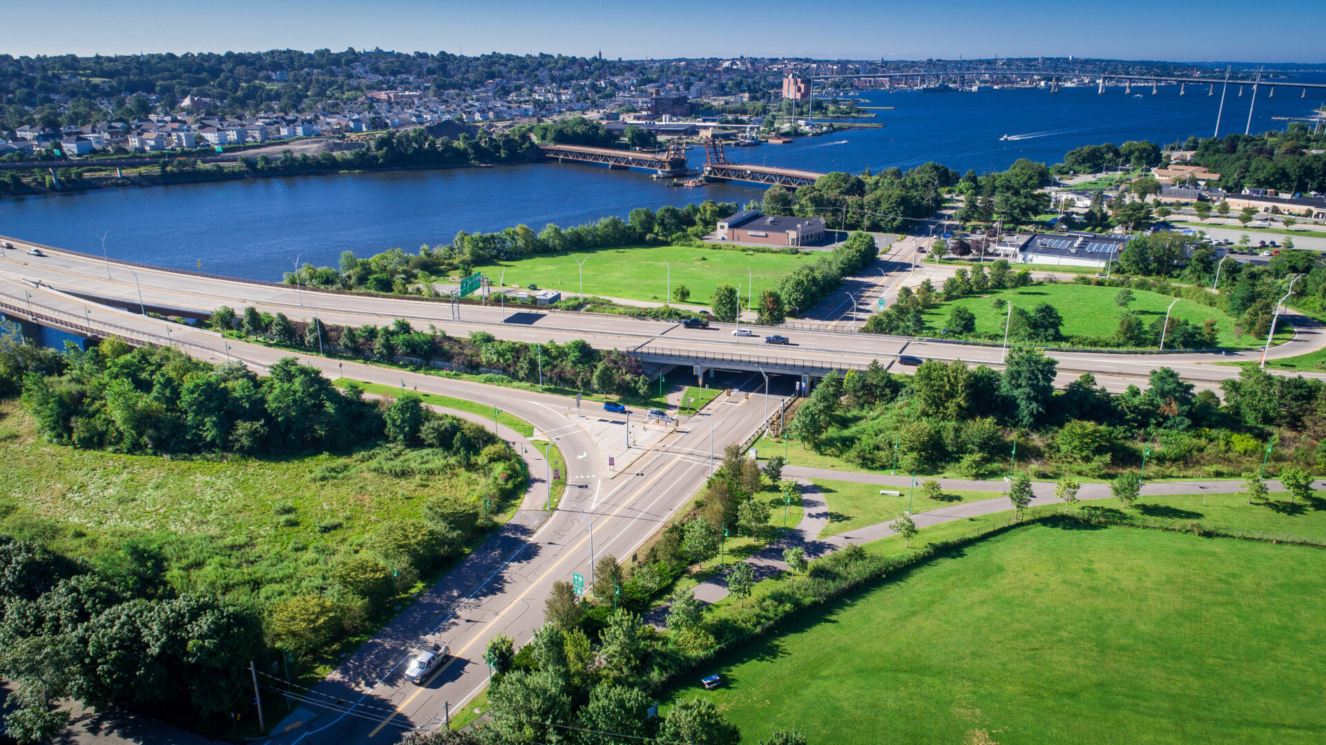 An aerial photo of the Slades Ferry Crossing District in Somerset, showing the west side of the Veteran's Memorial Bridge and Route 6 crossing over Riverside Avenue.