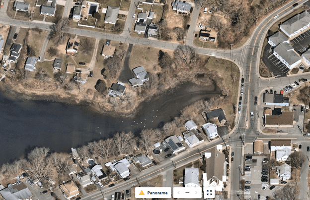 Aerial view of a marsh with houses and streets surrounding the area during winter