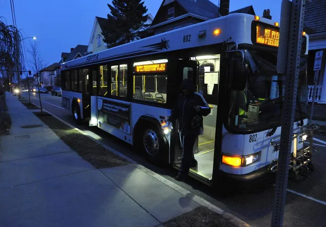 SRTA bus at night showing passengers boarding.
